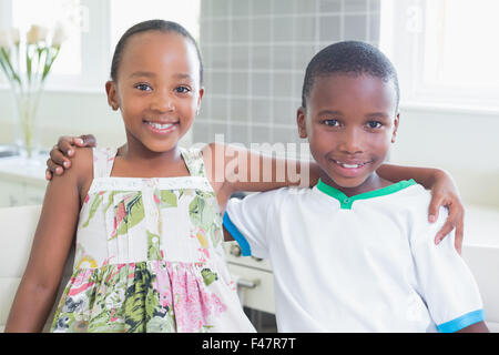 Happy siblings smiling at camera together Stock Photo - Alamy