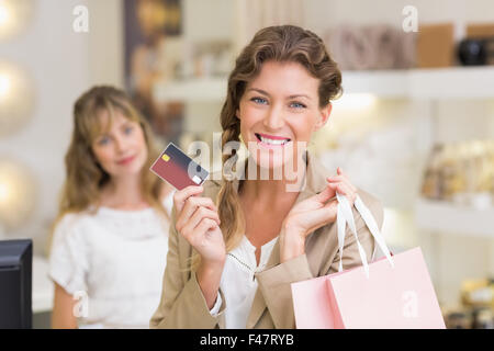 Beautiful customer at cash register holding credit card Stock Photo