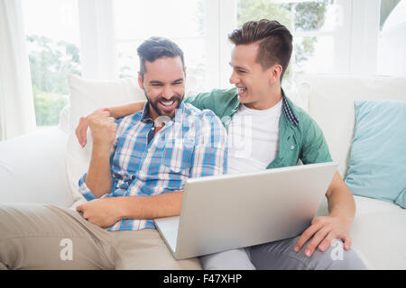 Homosexual couple men looking at laptop Stock Photo