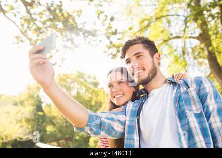 Cute couple doing selfie in the park Stock Photo