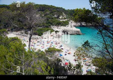 The clear azure waters of cala Mitjana from the cliffs above on the island of Menorca Spain Stock Photo