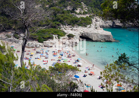 The clear azure waters of cala Mitjana from the cliffs above on the island of Menorca Spain Stock Photo