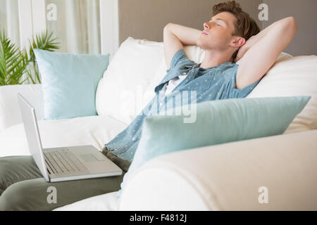 Young man relaxing on a sofa Stock Photo