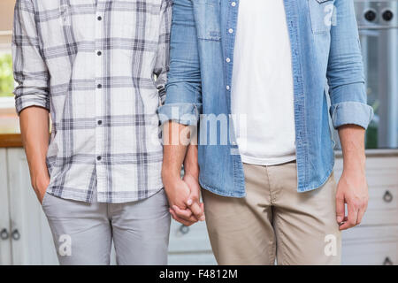 Homosexual couple standing and holding hands Stock Photo