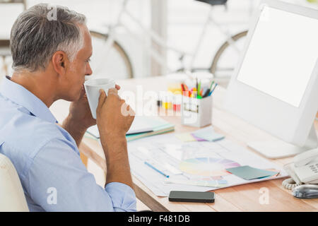 Creative businessman drinking a cup of tea Stock Photo