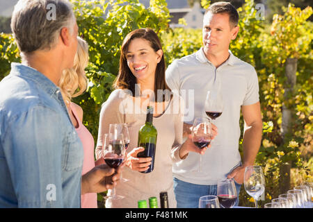 Happy friends talking and enjoying wine together Stock Photo