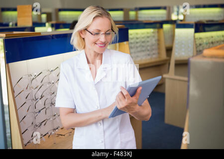 Optician using her tablet pc Stock Photo