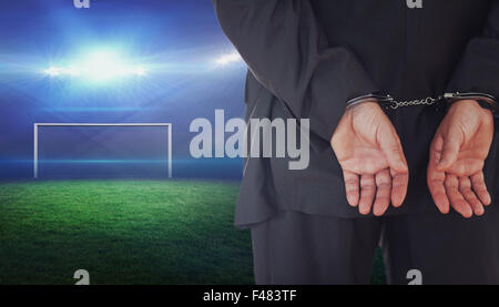Composite image of businessman in handcuffs Stock Photo