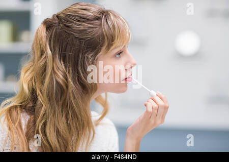 Beautiful costumer putting on makeup Stock Photo