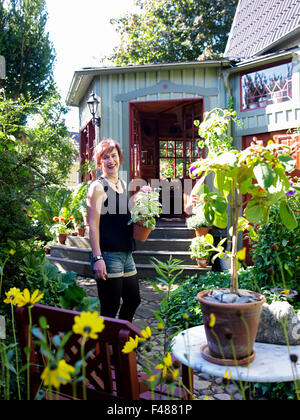 Woman in a garden, Sweden. Stock Photo