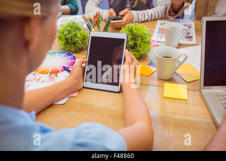 Rear view of casual businesswoman using tablet Stock Photo
