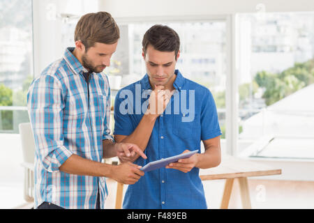 Creative businessmen working together on tablet Stock Photo