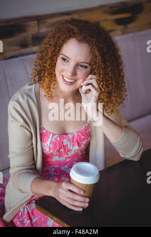 Happy smiling woman drinking coffee and phoning Stock Photo