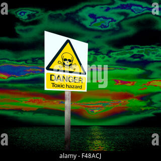 A toxic hazard warning sign in a digital image illustrating a world of polluted air and sea. Stock Photo