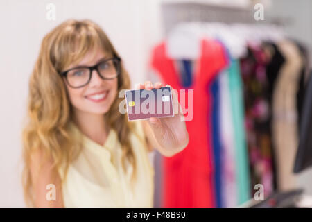 Beautiful employee holding credit card Stock Photo
