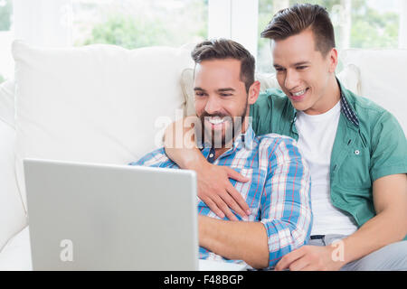 Homosexual couple men looking at laptop Stock Photo