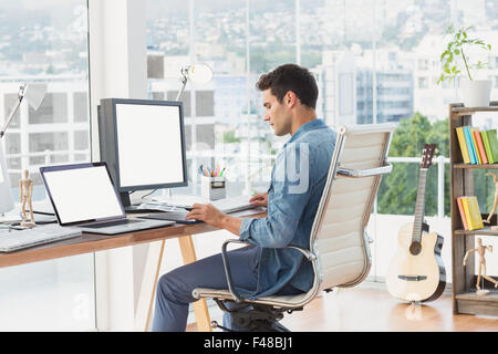 Casual businessman working at his desk Stock Photo