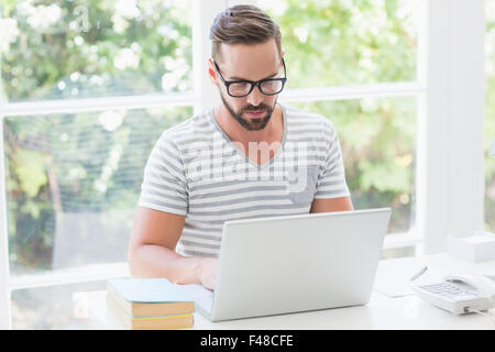Happy handsome man using his laptop computer Stock Photo