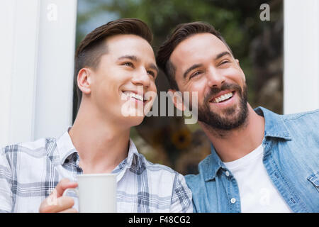 Happy homosexual couple looking away Stock Photo