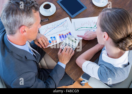 Serious business people using calculator Stock Photo
