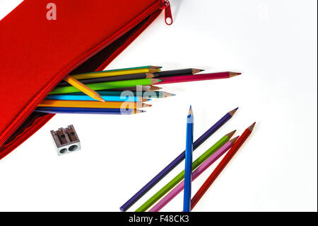 Red pencil case with coloured pencils and sharpener. Stock Photo