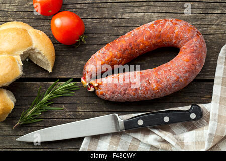Chorizo sausage on old wooden table Stock Photo - Alamy