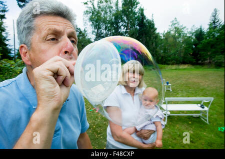 A man blowing a giant bubble, Sweden. Stock Photo