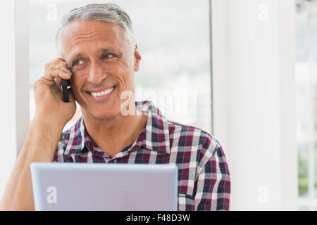 Smiling businessman holding a digital tablet Stock Photo