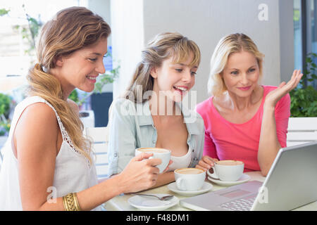 Beautiful women using laptop and smiling Stock Photo