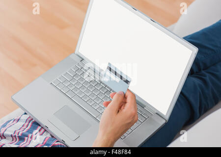 Happy man shopping online through laptop using credit card Stock Photo