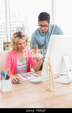 Concentrated colleagues looking photos together Stock Photo
