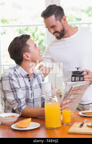 Happy homosexual couple looking at each other during breakfast Stock Photo