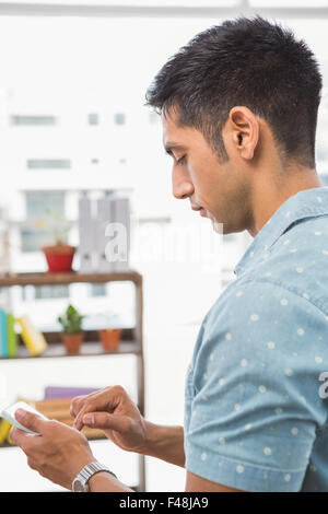 Concentrated casual businessman using smartphone Stock Photo