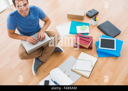 Young businessman working on the floor with tablet Stock Photo