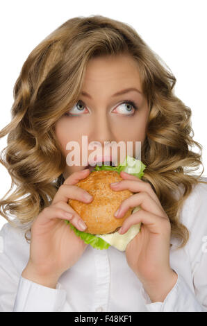 Young woman biting burger and looking away Stock Photo