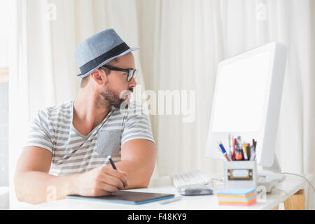 Handsome designer working on tablet computer Stock Photo
