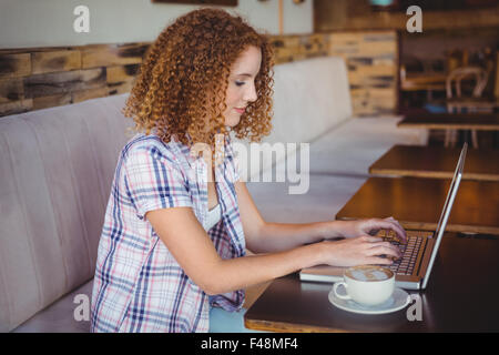 Happy smiling woman using her laptop Stock Photo