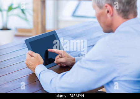 Serious businessman using tablet computer Stock Photo