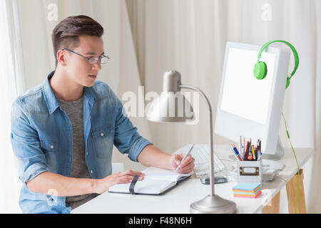 Handsome man writing on notebook Stock Photo