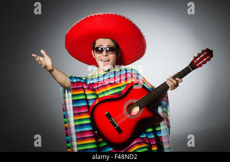 Man in red sombrero playing guitar Stock Photo