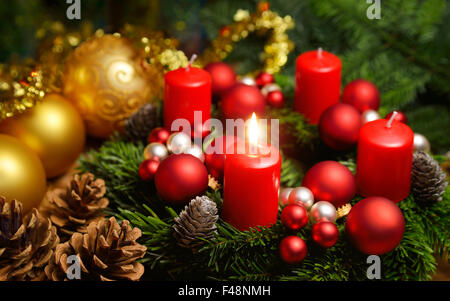 Studio shot of a nice advent wreath with baubles and one burning red candle Stock Photo