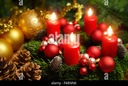 Studio shot of a nice advent wreath with baubles and four burning red candles Stock Photo