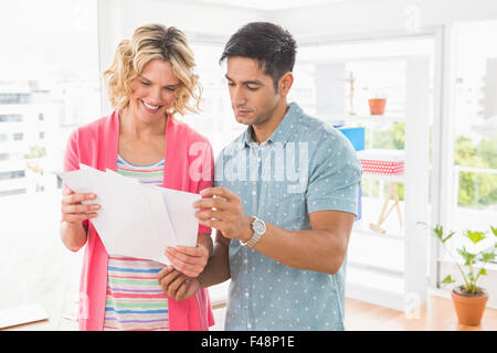 Colleagues standing and reading documents Stock Photo
