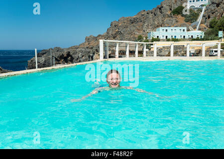 Woman swimming in a swimming pool, Kalypso Cretan Village Hotel, Karavos, Plakias,  Rethymno regional unit, Crete, Greece Stock Photo