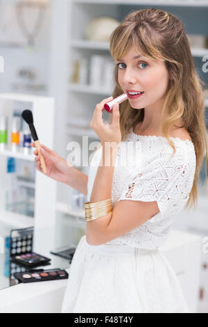 Beautiful costumer putting on makeup Stock Photo