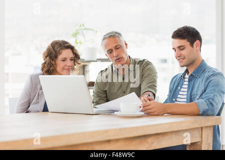 Creative business people using laptop in meeting Stock Photo