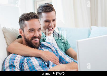 Homosexual couple men looking at laptop Stock Photo