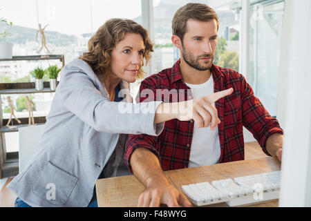 Creative business partners working on computer together Stock Photo