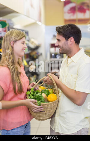 Smiling bright couple buying food products Stock Photo