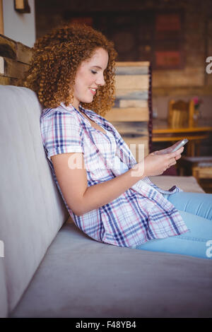 Happy smiling woman using her smartphone Stock Photo